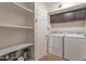 Convenient laundry room with washer, dryer, and storage shelves at 4704 E Paradise Village N Pkwy # 239, Phoenix, AZ 85032