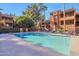 Community pool with lounge chairs and umbrellas at 4704 E Paradise Village N Pkwy # 239, Phoenix, AZ 85032