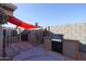 Outdoor kitchen with a built-in grill, shaded patio, and plenty of counter space at 4938 W Michelle Dr, Glendale, AZ 85308