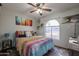 Bedroom with a queen bed, ceiling fan, and window seat at 4938 W Michelle Dr, Glendale, AZ 85308