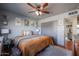 Bright bedroom with a queen bed, ceiling fan, and large closet at 4938 W Michelle Dr, Glendale, AZ 85308