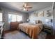 Cozy bedroom with large bed, dresser, and warm color scheme at 4938 W Michelle Dr, Glendale, AZ 85308