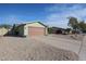 Single story home with a two car garage and a gravel driveway at 4938 W Michelle Dr, Glendale, AZ 85308