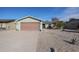 Light green single story home with a two-car garage and a rock front yard at 4938 W Michelle Dr, Glendale, AZ 85308