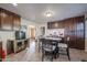 Bright kitchen features dark wood cabinets, granite countertops, and a breakfast bar at 4938 W Michelle Dr, Glendale, AZ 85308