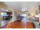 Open living area with hardwood floors, a ceiling fan, and views into the kitchen at 4938 W Michelle Dr, Glendale, AZ 85308