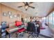 Sunroom workspace with a red chair and wood desk at 4938 W Michelle Dr, Glendale, AZ 85308