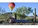 Sonoran Gate community entrance with hot air balloon overhead at 518 E Balao Dr, Phoenix, AZ 85085