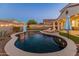 Inviting backyard oasis featuring a kidney-shaped pool and string lights at 518 E Balao Dr, Phoenix, AZ 85085