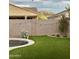 Backyard with pool, artificial turf, and string lights at 518 E Balao Dr, Phoenix, AZ 85085