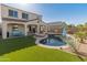 Relaxing backyard with a kidney-shaped pool and artificial turf at 518 E Balao Dr, Phoenix, AZ 85085