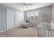 Bright bedroom with crib, chair, and large closet at 518 E Balao Dr, Phoenix, AZ 85085