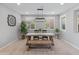 Dining room with a rustic wooden table, and a modern light fixture at 518 E Balao Dr, Phoenix, AZ 85085