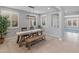 Dining room featuring a rustic wooden table, bench seating, and a modern light fixture at 518 E Balao Dr, Phoenix, AZ 85085