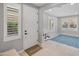 Bright entryway with tile flooring, a white door, and plantation shutters at 518 E Balao Dr, Phoenix, AZ 85085