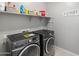 Laundry room with washer, dryer, and shelving for storage at 518 E Balao Dr, Phoenix, AZ 85085