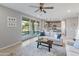 Living room with a sofa, coffee table, and view of the kitchen and backyard at 518 E Balao Dr, Phoenix, AZ 85085