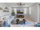 Living room featuring a comfy sofa, large TV, and sliding glass doors to backyard at 518 E Balao Dr, Phoenix, AZ 85085