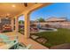 Inviting backyard pool with covered patio and string lights at 518 E Balao Dr, Phoenix, AZ 85085