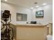 Basement wet bar with granite countertop, microwave, and seating area at 5301 E Calle Del Norte --, Phoenix, AZ 85018