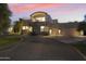 Luxury home with three-car garage, at dusk at 5301 E Calle Del Norte --, Phoenix, AZ 85018