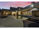 Evening view of a luxurious pool and patio area with lounge chairs and an umbrella at 5301 E Calle Del Norte --, Phoenix, AZ 85018