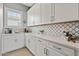 Well-equipped kitchen with white cabinets and a stylish backsplash at 5622 S Tobin Ave, Mesa, AZ 85212