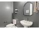 Stylish powder room with a pedestal sink and toilet at 5622 S Tobin Ave, Mesa, AZ 85212