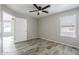 Bright bedroom with wood-look floors, ceiling fan, and window coverings at 5821 W Kesler St, Chandler, AZ 85226