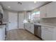 Updated kitchen with white cabinets, stainless steel appliances, and tile flooring at 5821 W Kesler St, Chandler, AZ 85226