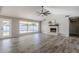 Spacious living area with a fireplace, tile floors, and sliding doors to backyard at 5821 W Kesler St, Chandler, AZ 85226