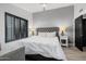 Bedroom with a king-size bed, gray walls, and black accents at 6131 E Kings Ave, Scottsdale, AZ 85254