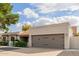 House exterior showcasing a two-car garage and neatly kept landscaping at 6131 E Kings Ave, Scottsdale, AZ 85254