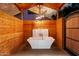 Relax in this luxurious outdoor bathtub with wood accents at 6131 E Kings Ave, Scottsdale, AZ 85254