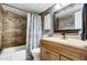 Updated bathroom with wood-look tile and modern vanity at 723 S Edgewater Dr, Mesa, AZ 85208