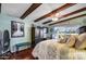 Bedroom with wood beams, ceiling fan, and tranquil view at 723 S Edgewater Dr, Mesa, AZ 85208