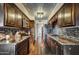 Modern kitchen featuring dark wood cabinets and granite countertops at 723 S Edgewater Dr, Mesa, AZ 85208