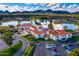 Aerial view of community with lake, clubhouse, and mountain backdrop at 7500 E Mccormick Pkwy # 78, Scottsdale, AZ 85258