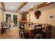 Rustic dining room with wood table, built-in hutch, and French doors leading to a patio at 7500 E Mccormick Pkwy # 78, Scottsdale, AZ 85258