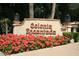 Colonia Encantada entrance sign with flowering plants at 7500 E Mccormick Pkwy # 78, Scottsdale, AZ 85258