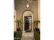 Open arched entryway with a dark wood door leading into the home at 7500 E Mccormick Pkwy # 78, Scottsdale, AZ 85258