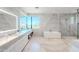 Luxury bathroom with marble finishes and soaking tub at 7537 N Lakeside Ln, Paradise Valley, AZ 85253