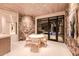 Cozy breakfast nook with stone accent wall and view of the backyard at 7537 N Lakeside Ln, Paradise Valley, AZ 85253