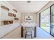 Bright dining room with a large table, built-in shelving, and access to the backyard at 7537 N Lakeside Ln, Paradise Valley, AZ 85253