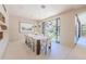 Bright dining room with a large table, built-in shelving, and access to the backyard at 7537 N Lakeside Ln, Paradise Valley, AZ 85253