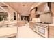 Modern kitchen with stainless steel appliances and light wood cabinetry at 7537 N Lakeside Ln, Paradise Valley, AZ 85253