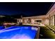 Stunning pool with spa and fire pit at night at 7537 N Lakeside Ln, Paradise Valley, AZ 85253