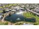 Aerial view of community with lake, golf course, and resort-style pool at 7756 E Coralbell Ave, Mesa, AZ 85208