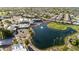 Aerial view of community with pool, clubhouse, and lake at 7756 E Coralbell Ave, Mesa, AZ 85208