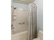 Clean bathroom with a tub shower and patterned curtain at 7756 E Coralbell Ave, Mesa, AZ 85208